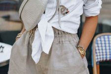 18 a casual brunch outfit with a white tied up shirt, grey linen shorts with pockets, a grey waistbag and layered necklaces for a hot day