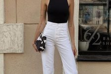 20 a black halter neckline top, white high waisted jeans, black strappy shoes, a chunky chain necklace and statement earrings
