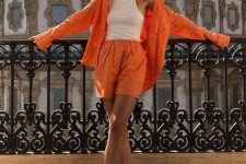 20 a linen orange co-ord with an oversized shirt and shorts, a white halter neckline top and brown leather sandals