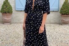 21 a black polka dot midi dress with a plunging neckline, a chic bag with chain and bold green shoes are a nice idea for a summer date