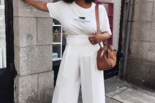 22 a cool and stylish casual work look with a white printed t-shirt, white wideleg pants, white peep toe shoes and a brown bag