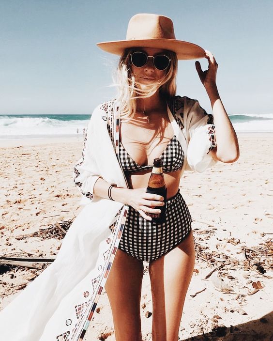 a lovely retro-inspired black and white checked swimsuit wiht a bra and a high waisted bottom, a boho cover up and a lovely hat