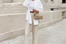 24 a neutral and simple summer work look with a white halter neckline top and an oversized shirt, neutral linen pants, brown slippers and a grey quilted bag
