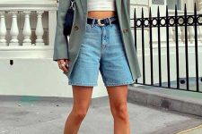 24 a summer casual look with a white crop top, blue denim shorts, a black belt, a sage green oversized blazer, white socks and trainers