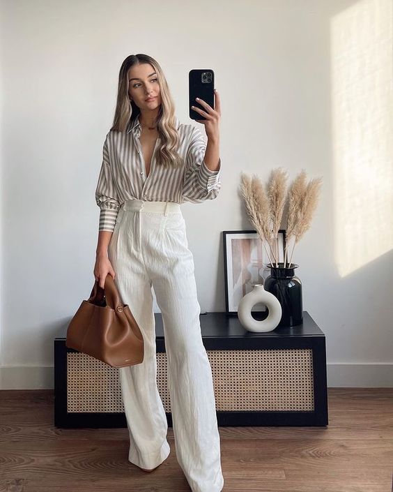 a simple and cool summer work look with a striped grey and white shirt, creamy high waisted pants, a brown bag are a lovely outfit to try
