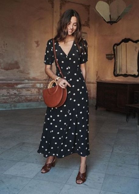 a simple and romantic outfit with a black polka dot midi dress, brown mules and a brown bag with round handles is a cool idea for summer or summer to fall transition