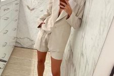 a tan linen suit with shorts, matching lace up chunky sandals are a great combo for a stylish office look on a hot summer day