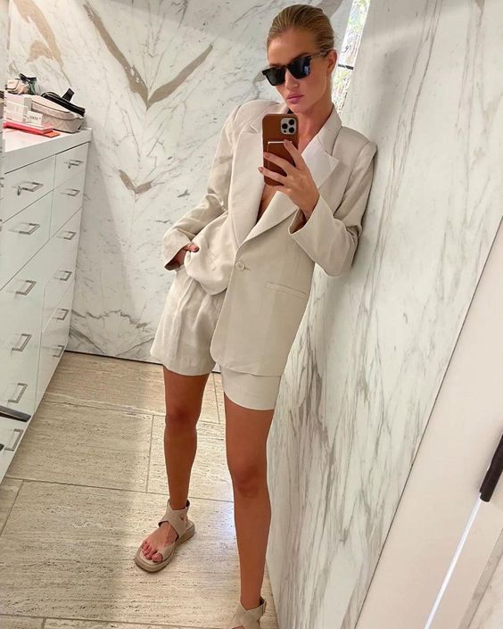 a tan linen suit with shorts, matching lace up chunky sandals are a great combo for a stylish office look on a hot summer day