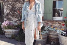 28 a white polka dot midi skirt with a thigh high slit, a bleached denim jacket and a black bag for summer