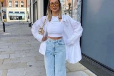30 a white crop top, a white oversized shirt, bleached jeans, white sneakers and a tan bag are great for spring or summer