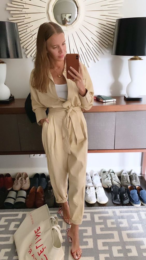 a white tank top, a light yellow linen cargo jumpsuit, red shoes compose a bold and chic summer career look