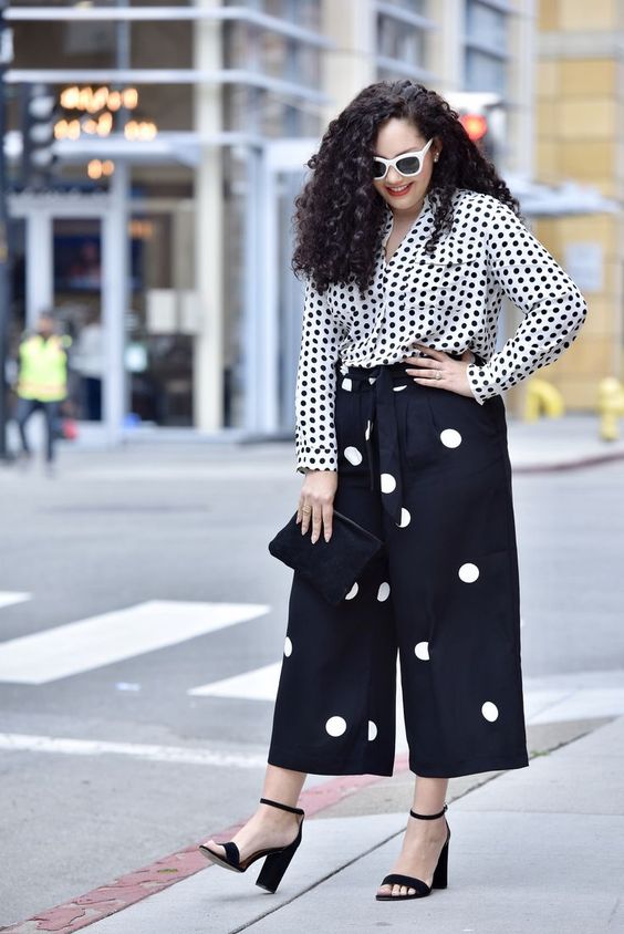 a catchy total polka dot look with a shirt and culottes, black heels and a black handbag are a lovely and playful outfit