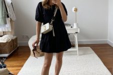 39 a black cotton A-line dress, black birkenstocks and a white bag with a gold logo are a chic combo for every day