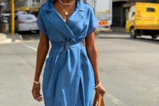 40 a blue denim wrap dress with a belt and an amber leather tote, layered necklaces for a lovely summer look