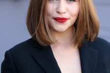 Emilia Clarke wearing a dark brunette clavicut with a touch of balayage and side parting is timeless classics