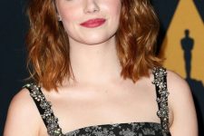 Emma Stone rocking red messy waves done in a clavicut looks bright and all-cool