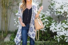 With black top, beige leather bag, navy blue skinny cropped jeans and white heeled shoes