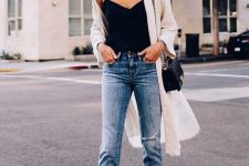 With black top, black leather chain strap bag, cropped jeans, sunglasses and black and beige shoes