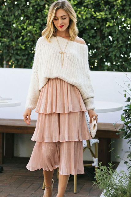 With golden necklace, white one shoulder oversized sweater, white embellished clutch and beige ankle strap shoes