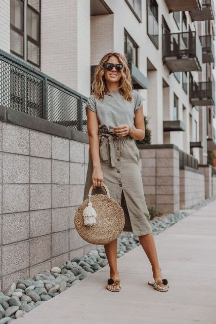 With gray t-shirt, oversized sunglasses, beige rounded tassel bag and pom pom flat sandals
