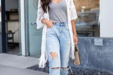 With gray top, oversized sunglasses, light blue distressed jeans, beige high heels and beige leather mini bag