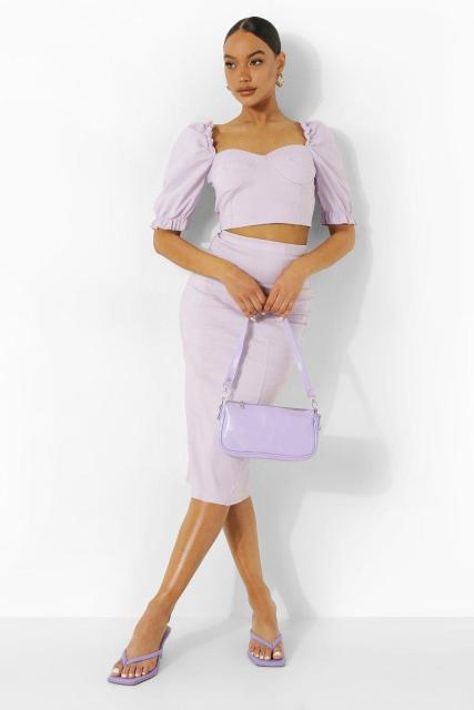 With lilac high-waisted midi skirt, lilac leather mini bag and lilac heeled sandals