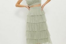 With mint green ruffled crop top and silver lace up sandals