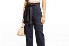 With navy blue belted high-waisted jeans, beige leather bag and beige leather heeled mules