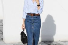 With oversized sunglasses, black leather backpack, light blue button down loose shirt and white lace up flat shoes