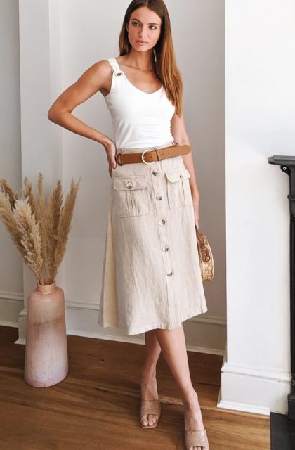 With white fitted top, straw rounded bag and beige leather low heeled sandals