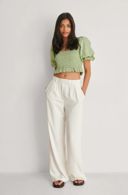 With white loose pants and brown flat sandals