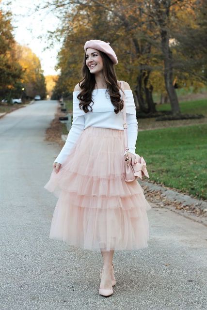 With white off the shoulder long sleeved shirt, pale pink beret, pale pink leather bag and pale pink pumps