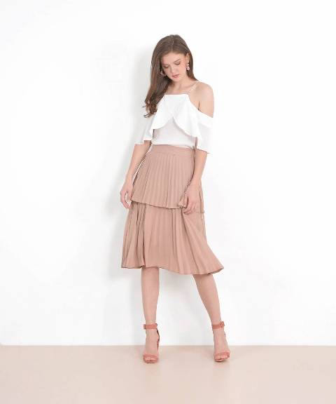 With white ruffled off the shoulder blouse and pale pink ankle strap heeled shoes