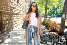 With white t-shirt, white and black striped culottes, mirrored sunglasses, black and white polka dot tote bag and brown leather flat sandals