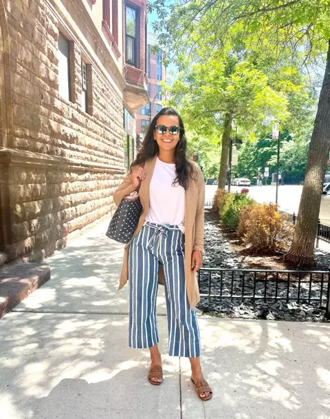 With white t-shirt, white and black striped culottes, mirrored sunglasses, black and white polka dot tote bag and brown leather flat sandals
