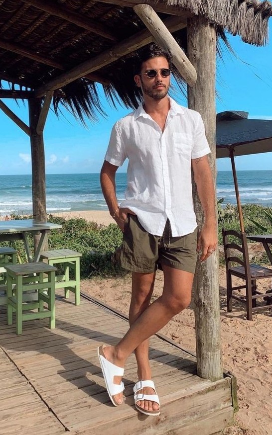 a beach date outfit with a white short sleeve linen shirt, brown shorts and white birkenstocks is easy to repeat and looks cool