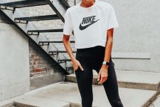 a black and white workout look with black leggings,  a white printed cropped t-shirt, white trainers