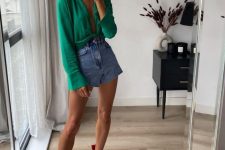 a bold party look with an emerald knotted shirt, blue denim shorts and red heels with fringe on the back