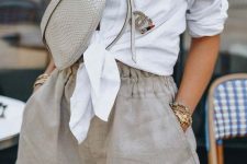 a casual brunch outfit with a white tied up shirt, grey linen shorts with pockets, a grey waistbag and layered necklaces for a hot day