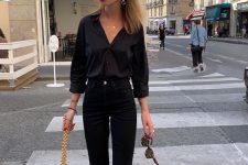 a chic total black look with a silk shirt, cropped jeans, strappy heels and a neutral beaded bag and exquisite accessories
