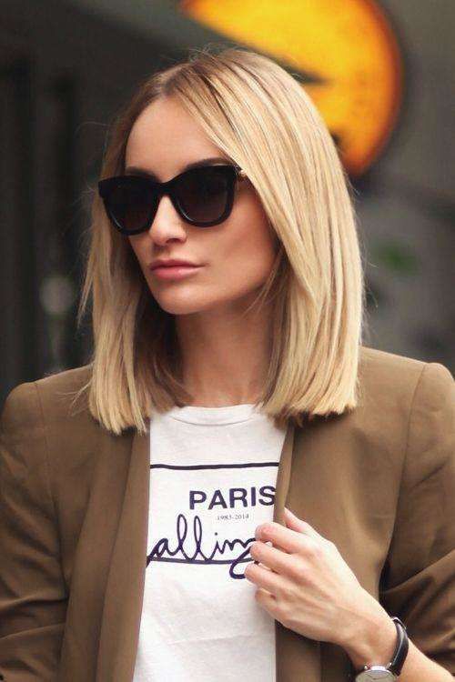 a classic blonde clavicut with sleek and voluminous hair and curtain bangs looks very up-to-date and very stylish