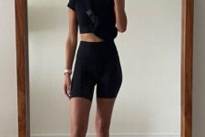 a classy and comfy workout look with a black crop top, black biker shorts, white socks and trainers is ideal for sport