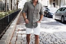a classy summer dat elook with a grey linen shirt and white denim shorts, white sneakers is a nice example of what to wear on a hot day