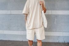 a comfortable all-neutral summer look with an oversized tan t-shirt, shorts, white sneakers and socks, a white tote is super cool