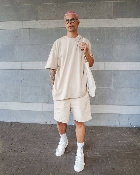 a comfortable all neutral summer look with an oversized tan t shirt, shorts, white sneakers and socks, a white tote is super cool