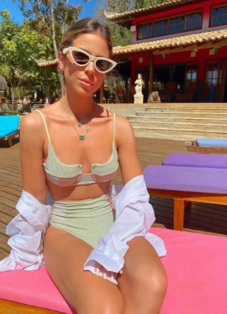a delicate sparkle light green bikini with a bra top and a high waisted bottom, layered green necklaces and a shirt cover up