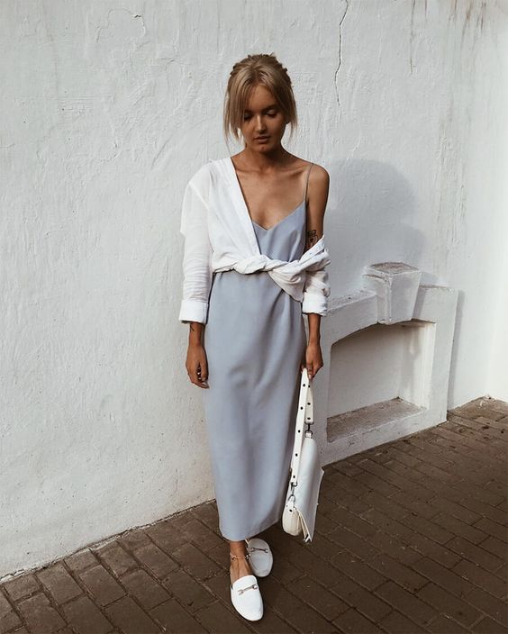 a dusty blue slip midi dress, a knotted white button down, white slippers and a white bag for a relaxed and chic summer look