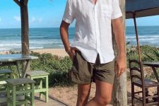 a holiday look with a white short sleeve linen shirt, brown shorts and white birkenstocks is easy to repeat and looks cool
