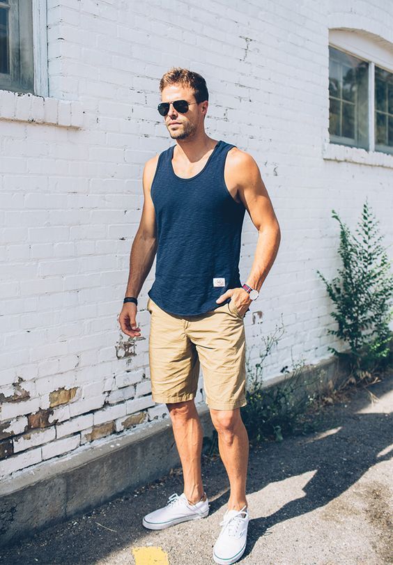a hot day look with a navy tank top, beige shorts and white sneakers is a comfy idea during a heat strike