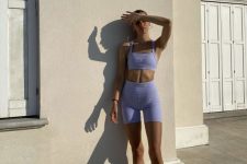 a lilac workout set with a bra top, biker shorts, white socks and grey trainers is a lovely idea for summer workouts